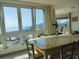 Enjoy breathtaking lake and mountain views from this stunning dining area, perfect for entertaining.