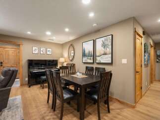 This inviting dining area features a dark wood dining table with six chairs, perfect for family gatherings.