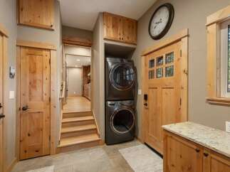 Discover a functional and stylish laundry area featuring a stacked washer and dryer, perfect for maximizing space.