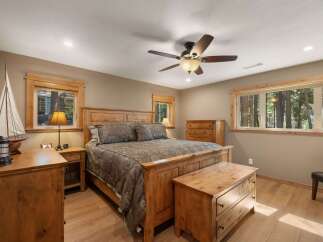 Experience rustic charm in this inviting bedroom, featuring a sturdy wooden bed frame and matching furniture.