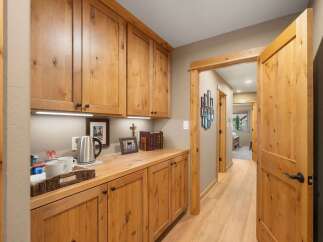 Discover this charming home featuring a convenient coffee bar area with ample cabinet storage and a sleek electric kettle.