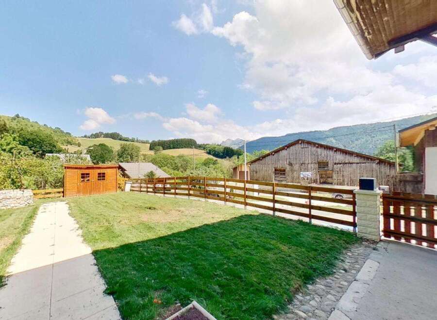 Discover this charming property featuring a well-maintained lawn and a rustic wooden shed, perfect for storage or a small workshop.