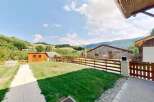 Discover this charming property featuring a well-maintained lawn and a rustic wooden shed, perfect for storage or a small workshop.