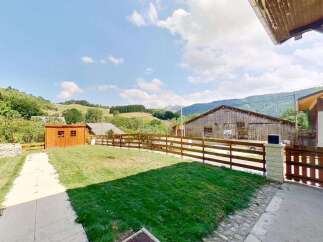 Discover this charming property featuring a well-maintained lawn and a rustic wooden shed, perfect for storage or a small workshop.