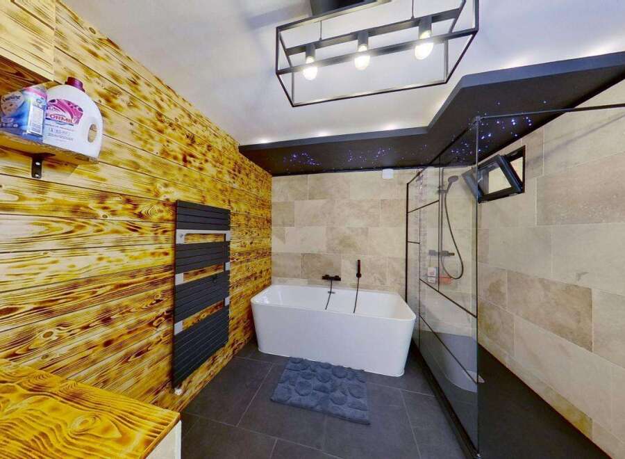 Experience ultimate relaxation in this luxurious bathroom, featuring a stunning freestanding bathtub and a modern glass-enclosed shower.