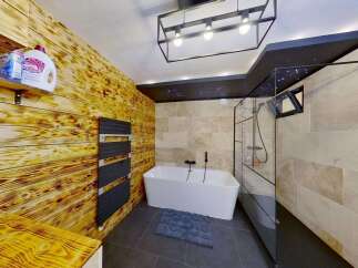 Experience ultimate relaxation in this luxurious bathroom, featuring a stunning freestanding bathtub and a modern glass-enclosed shower.