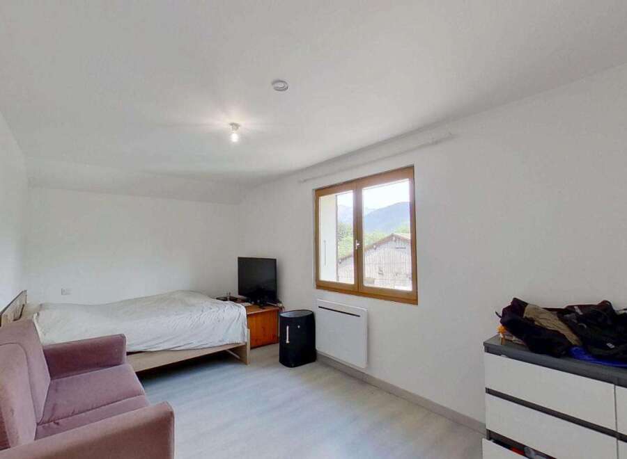 Discover this charming room featuring a comfortable bed and a cozy sofa, perfect for relaxation.