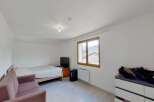 Discover this charming room featuring a comfortable bed and a cozy sofa, perfect for relaxation.