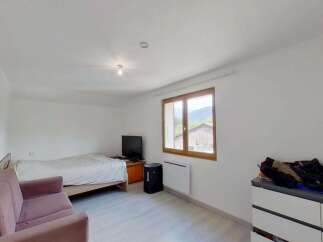 Discover this charming room featuring a comfortable bed and a cozy sofa, perfect for relaxation.