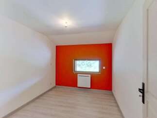 This room features a striking orange accent wall, creating a vibrant focal point.