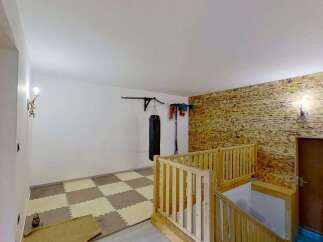 Discover a versatile space perfect for your fitness goals, featuring a professional-grade punching bag and pull-up bar.