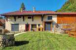 Discover this charming property featuring a traditional stone well and a lush green lawn, perfect for outdoor relaxation.