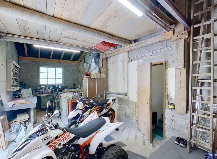 Discover this versatile garage space, perfect for storing vehicles like motorcycles and ATVs, or as a workshop area.