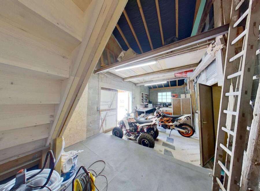 Discover this versatile garage space, perfect for storing vehicles like ATVs and motorcycles.