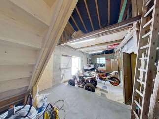 Discover this versatile garage space, perfect for storing vehicles like ATVs and motorcycles.