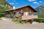 Nestled against a majestic mountain backdrop, this charming chalet offers a serene retreat.