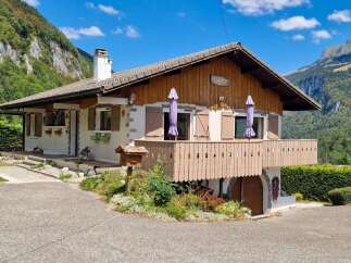 Nestled against a majestic mountain backdrop, this charming chalet offers a serene retreat.