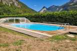 Enjoy a refreshing dip in this stunning outdoor swimming pool, complete with a retractable cover for year-round use.