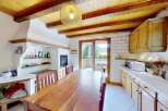 Discover this charming kitchen featuring a rustic wooden dining table perfect for family meals.