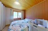 Experience cozy mountain living in this charming bedroom featuring a comfortable bed with a nature-inspired duvet cover.