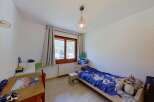 Discover this charming bedroom featuring a cozy single bed with playful bedding and a collection of stuffed animals.