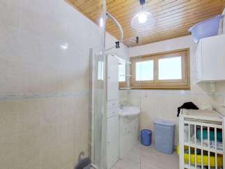 This charming bathroom features a modern shower enclosure and a sleek vanity with a sink, perfect for a quick refresh.