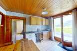 Discover this charming kitchen featuring warm wooden cabinetry and a spacious countertop perfect for meal preparation.