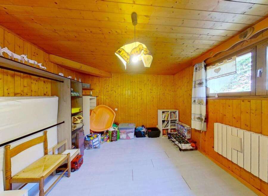 Discover this charming room with warm wooden paneling throughout, creating a cozy and inviting atmosphere.