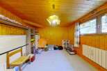 Discover this charming room with warm wooden paneling throughout, creating a cozy and inviting atmosphere.