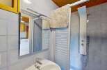 This charming bathroom features a modern shower panel with a rainfall showerhead, perfect for a relaxing experience.