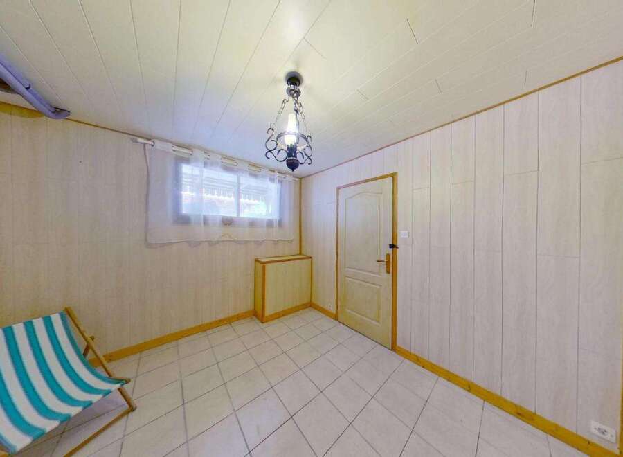 Discover this charming room featuring a striped deck chair, perfect for relaxation.