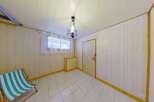 Discover this charming room featuring a striped deck chair, perfect for relaxation.