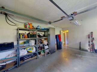 Discover ample storage solutions in this versatile garage space, perfect for organizing all your recreational gear and equipment.