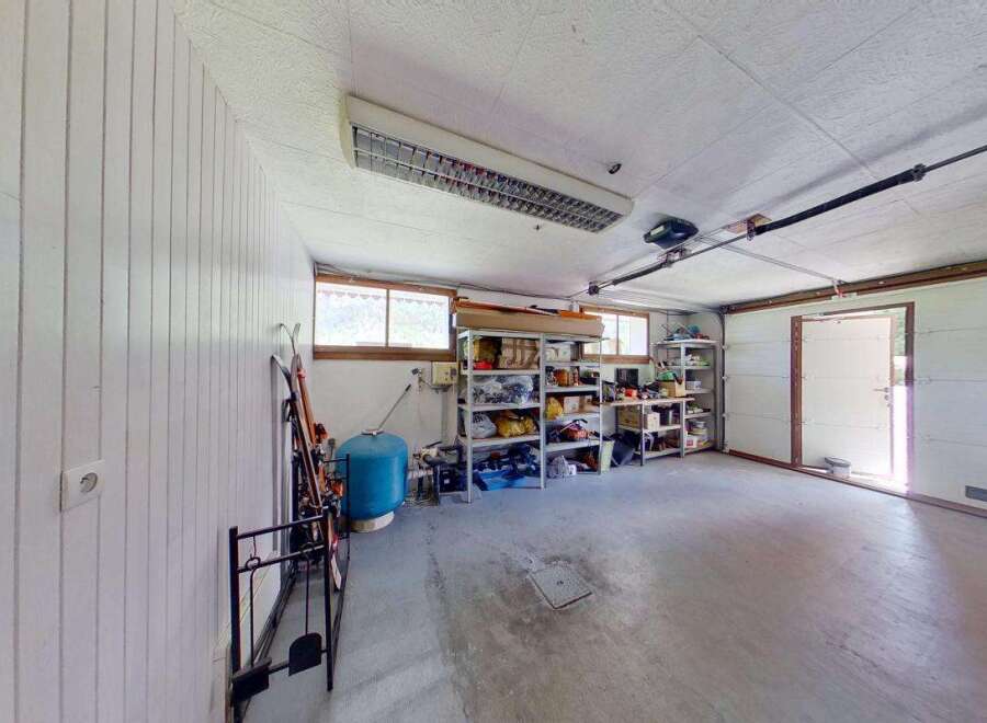 Discover ample storage solutions in this versatile garage space, featuring multiple shelving units perfect for organizing tools, sports equipment, and seasonal items.