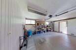 Discover ample storage solutions in this versatile garage space, featuring multiple shelving units perfect for organizing tools, sports equipment, and seasonal items.