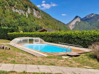 Escape to this stunning mountain retreat featuring a beautiful swimming pool with a retractable cover, perfect for year-round enjoyment.