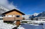 Experience the charm of this picturesque mountain chalet, nestled amidst a winter wonderland.
