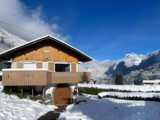 Experience the charm of this picturesque mountain chalet, nestled amidst a winter wonderland.