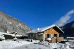 Experience the ultimate winter getaway in this charming chalet nestled amidst snow-covered mountains.
