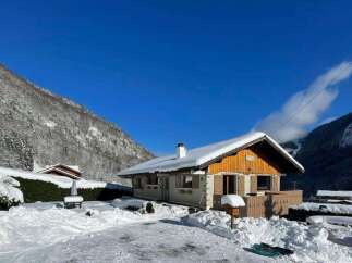 Experience the ultimate winter getaway in this charming chalet nestled amidst snow-covered mountains.
