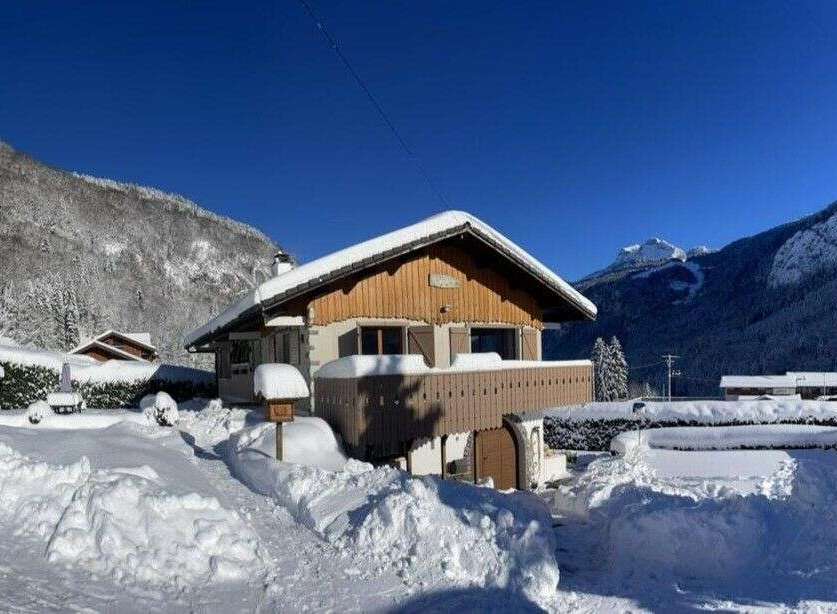 Experience the charm of a winter wonderland with this picturesque chalet nestled in the snowy mountains.