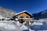 Experience the charm of a winter wonderland with this picturesque chalet nestled in the snowy mountains.