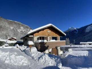 Experience the charm of a winter wonderland with this picturesque chalet nestled in the snowy mountains.