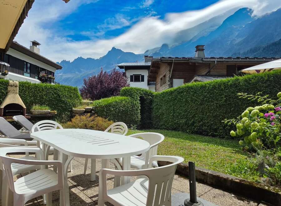 Enjoy breathtaking mountain views from this charming property's outdoor patio, complete with a dining set and lounge chairs.