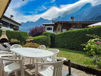 Enjoy breathtaking mountain views from this charming property's outdoor patio, complete with a dining set and lounge chairs.
