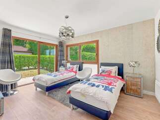 This charming bedroom features two twin beds with patriotic-themed bedding, perfect for a guest room or children's space.