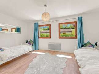 This charming bedroom features two twin beds, perfect for accommodating guests or children.