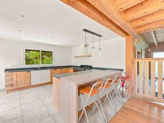 Discover this charming kitchen featuring a spacious island with bar seating, perfect for casual dining and entertaining.