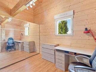Discover this charming wooden room, perfect for a home office or study.
