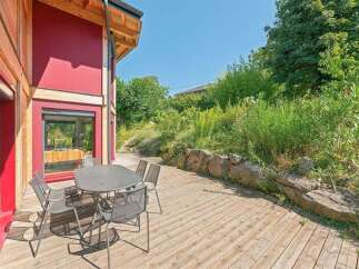 Enjoy outdoor living on this spacious wooden deck, perfect for al fresco dining or relaxing with a view.